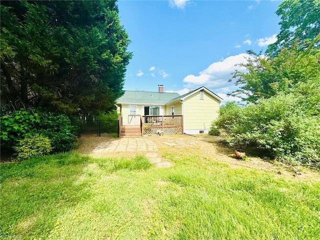 back of property with a deck and a chimney