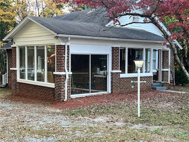 view of side of home featuring a sunroom