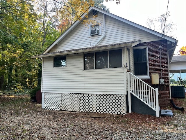 view of side of property featuring central air condition unit and cooling unit