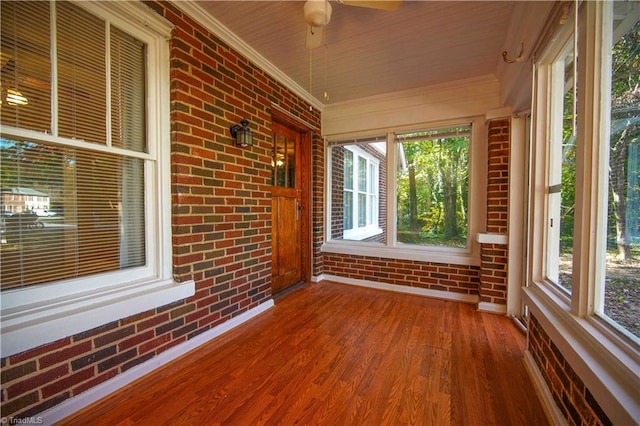 unfurnished sunroom with wooden ceiling and ceiling fan