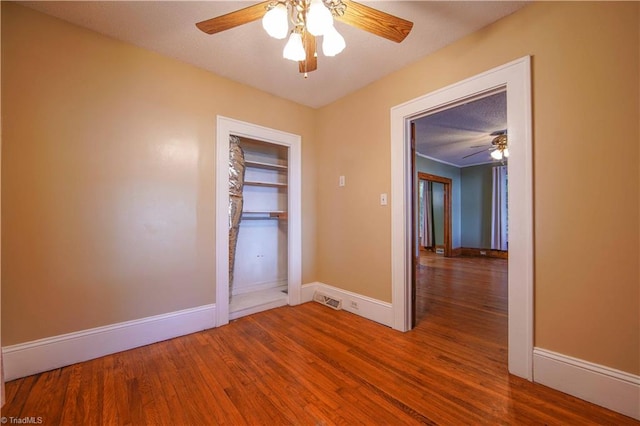 spare room with wood-type flooring and ceiling fan