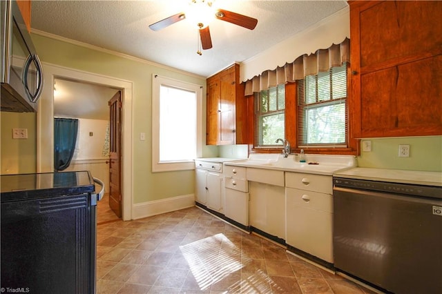 kitchen with ceiling fan, appliances with stainless steel finishes, a textured ceiling, and ornamental molding