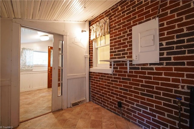 hallway with brick wall, wooden ceiling, and vaulted ceiling