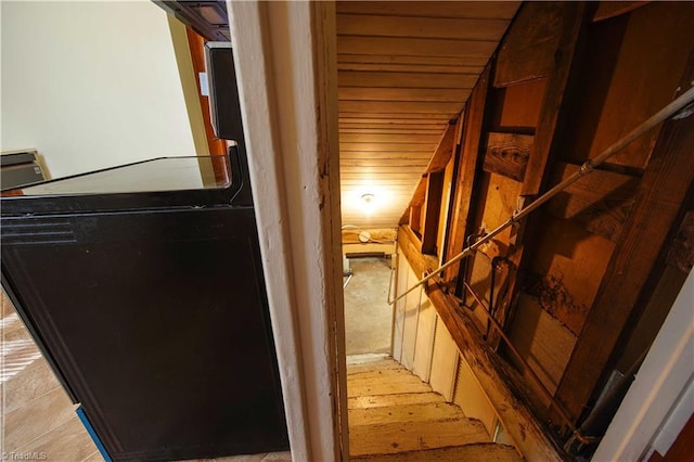 hall featuring light hardwood / wood-style floors and wooden ceiling