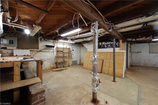 basement with electric panel and a workshop area