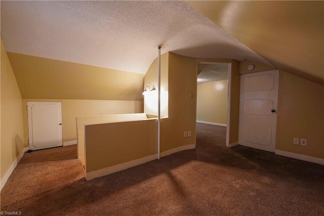 bonus room featuring a textured ceiling, carpet, and lofted ceiling