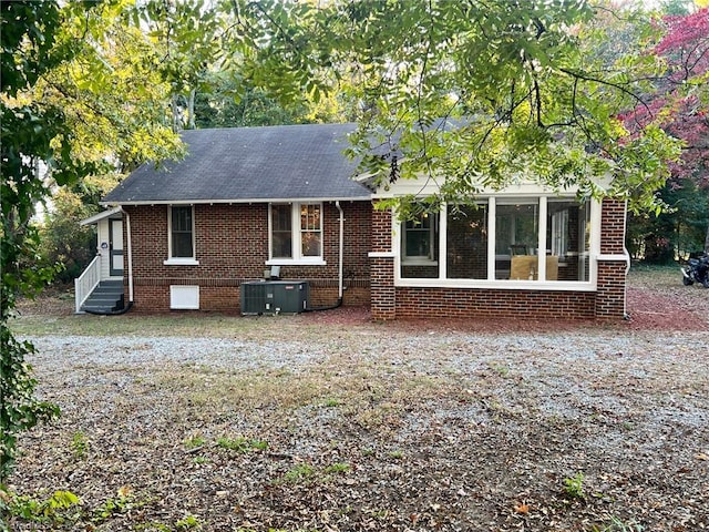 rear view of house featuring central AC