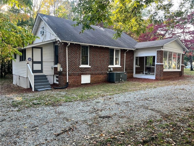 exterior space featuring a sunroom and central AC unit