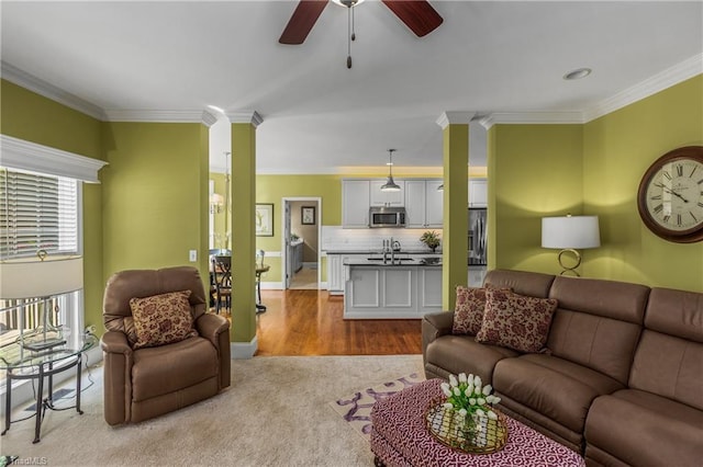 3116 Lodge Dr, Jamestown, NC 27282 - living area with decorative columns, ornamental molding, a ceiling fan, light carpet, and baseboards