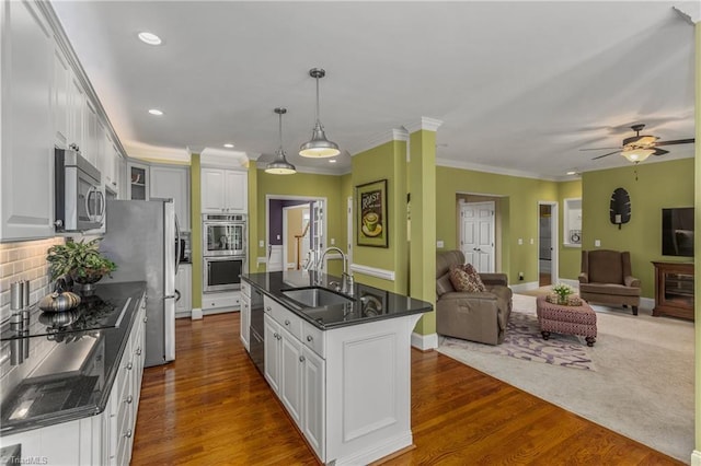 3116 Lodge Dr, Jamestown, NC 27282 - kitchen featuring appliances with stainless steel finishes, a sink, open floor plan, white cabinets, and recessed lighting