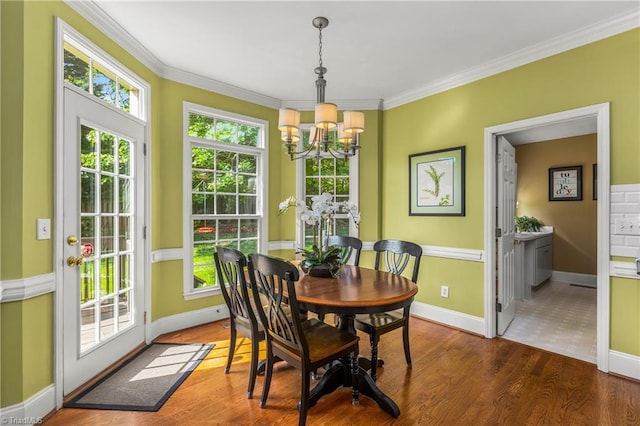 3116 Lodge Dr, Jamestown, NC 27282 - dining area with a chandelier, ornamental molding, baseboards, and wood finished floors