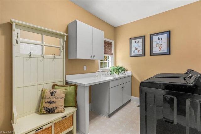 3116 Lodge Dr, Jamestown, NC 27282 - washroom with cabinet space, washer and clothes dryer, and baseboards