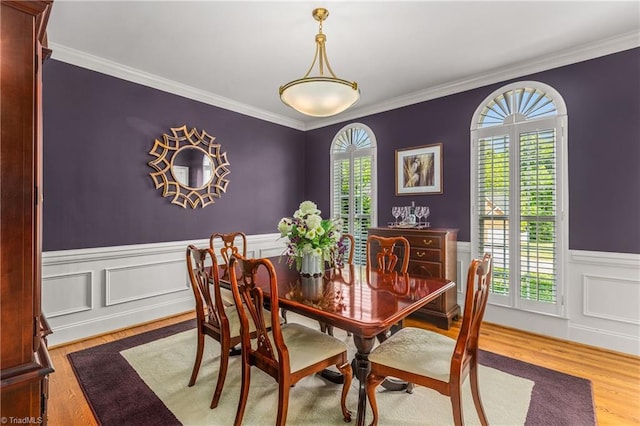 3116 Lodge Dr, Jamestown, NC 27282 - dining area with wood finished floors, crown molding, and a wainscoted wall