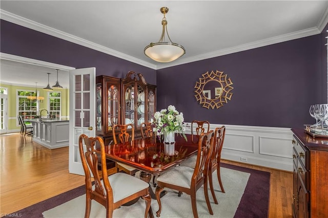 3116 Lodge Dr, Jamestown, NC 27282 - dining space featuring wood finished floors, crown molding, and a wainscoted wall