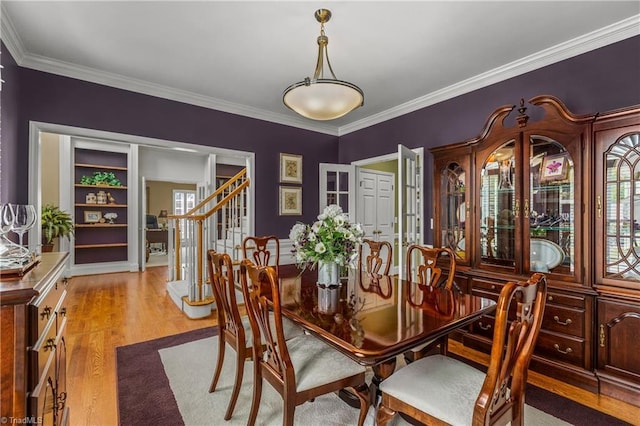 3116 Lodge Dr, Jamestown, NC 27282 - dining area featuring plenty of natural light, stairs, ornamental molding, and light wood-style flooring