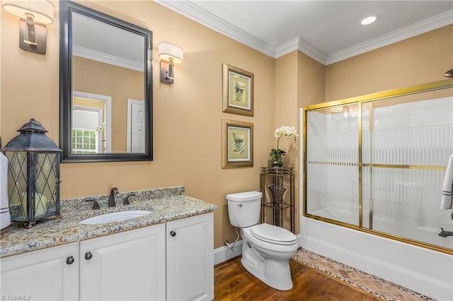 3116 Lodge Dr, Jamestown, NC 27282 - full bathroom with toilet, vanity, bath / shower combo with glass door, wood finished floors, and baseboards