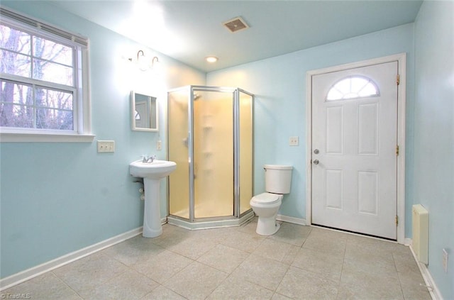 bathroom featuring visible vents, tile patterned flooring, a stall shower, baseboards, and toilet
