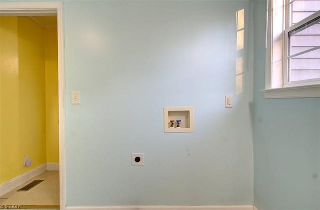 laundry room featuring visible vents, laundry area, baseboards, hookup for a washing machine, and hookup for an electric dryer