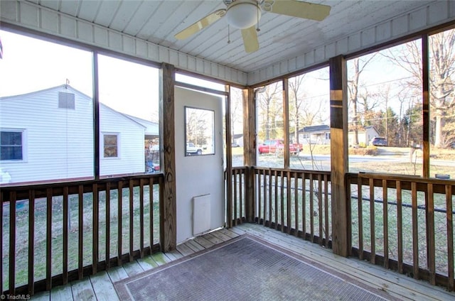unfurnished sunroom featuring plenty of natural light and a ceiling fan