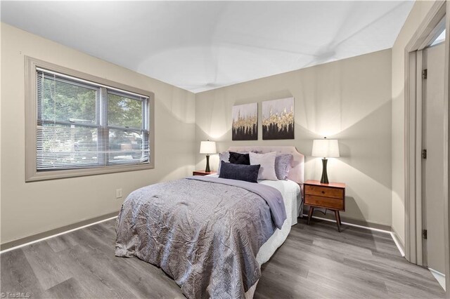 bedroom with wood-type flooring