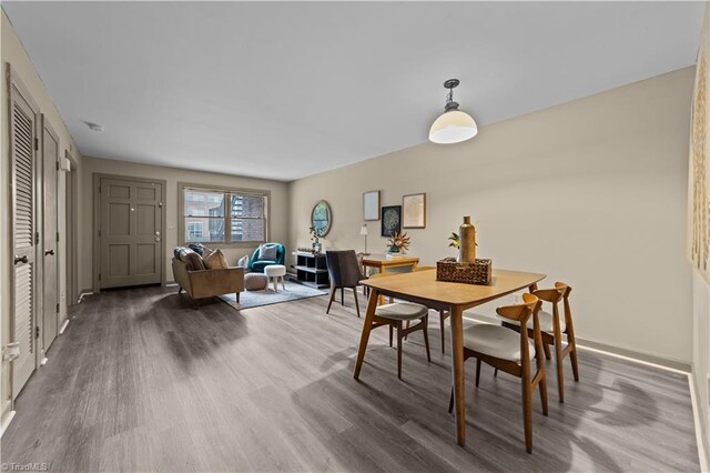 dining space featuring wood-type flooring