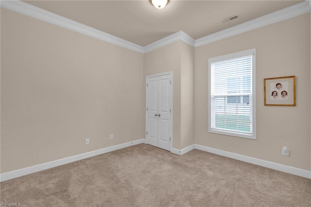 carpeted spare room with crown molding