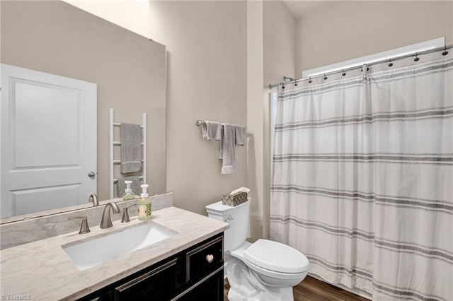 bathroom with toilet, a shower with curtain, vanity, and wood-type flooring