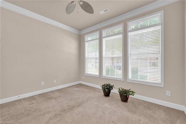 unfurnished room featuring ornamental molding, light carpet, and ceiling fan