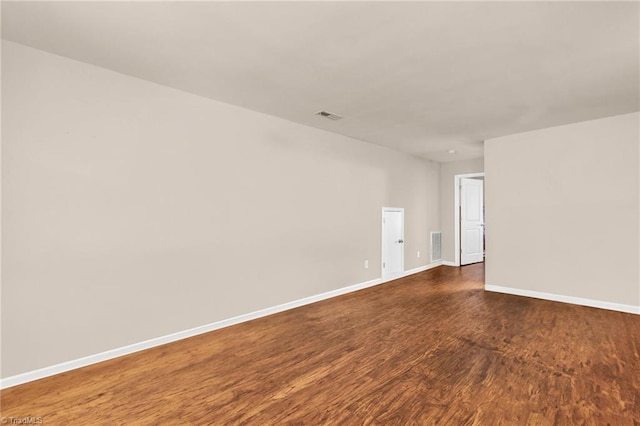 spare room featuring dark wood-type flooring