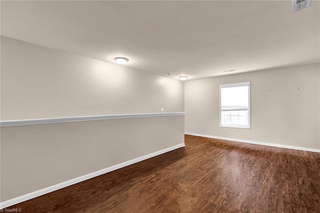 unfurnished room featuring dark wood-type flooring