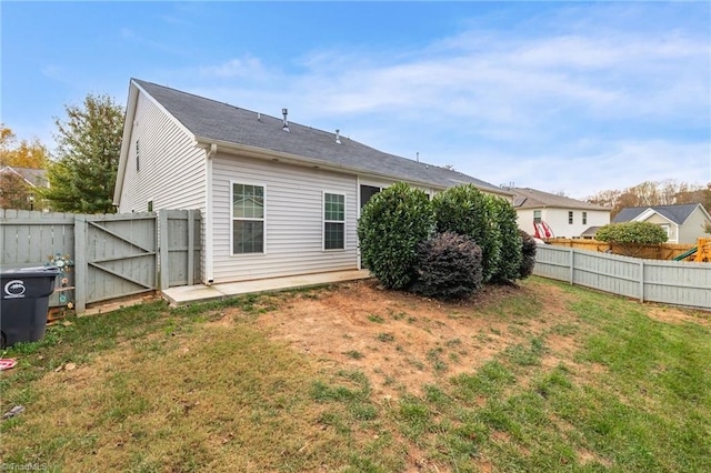 rear view of house featuring a lawn