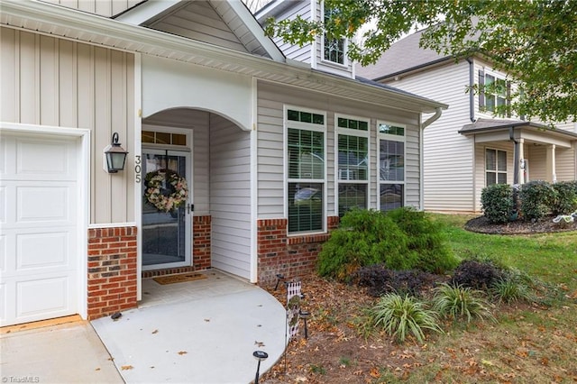 view of exterior entry with a garage