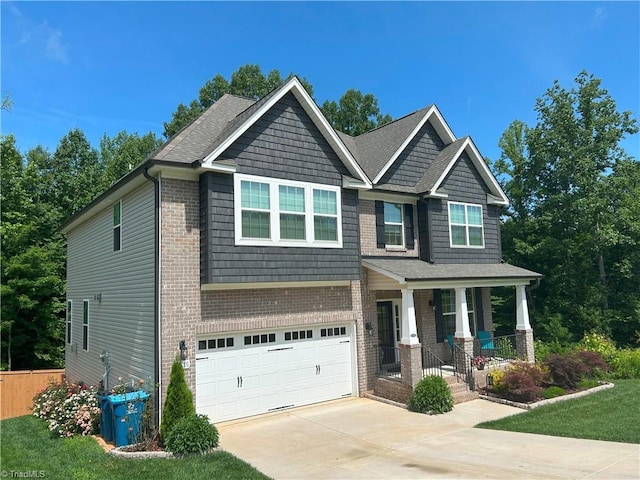 7615 Mary Ellen Ct, Greensboro, NC 27409 - craftsman-style house featuring covered porch, a garage, driveway, and brick siding