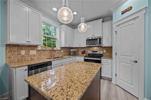 7615 Mary Ellen Ct, Greensboro, NC 27409 - kitchen featuring stainless steel appliances, white cabinetry, a center island, light stone counters, and recessed lighting