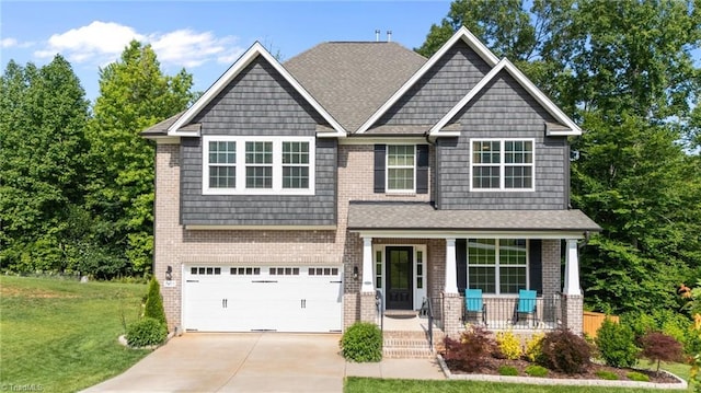 7615 Mary Ellen Ct, Greensboro, NC 27409 - craftsman house with a porch, a front lawn, driveway, a garage, and brick siding