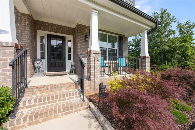 7615 Mary Ellen Ct, Greensboro, NC 27409 - doorway to property featuring covered porch and brick siding