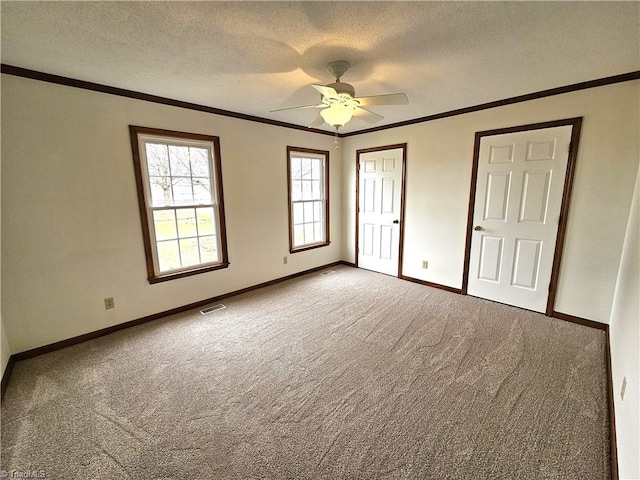 unfurnished bedroom featuring crown molding, ceiling fan, carpet, and a textured ceiling