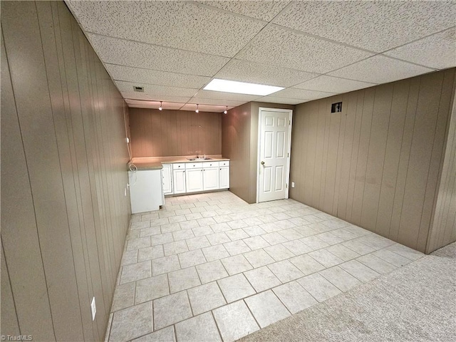 interior space with sink and wood walls