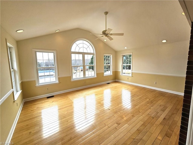 unfurnished room with vaulted ceiling, ceiling fan, and light hardwood / wood-style floors