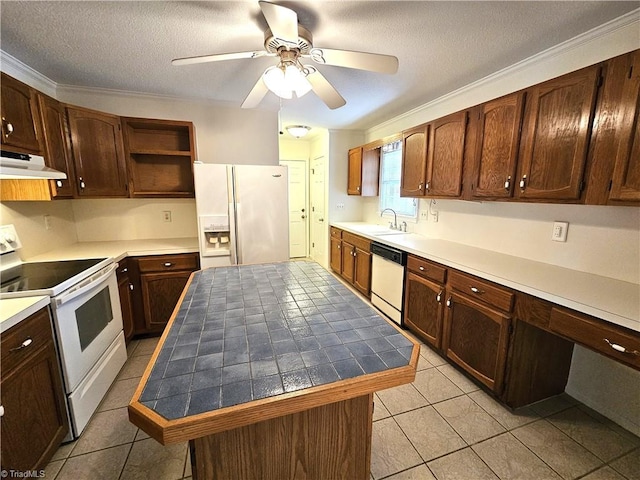 kitchen featuring sink, white appliances, a textured ceiling, a kitchen island, and ceiling fan