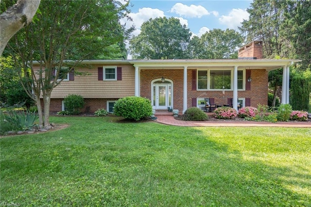 4770 Duffer Ln, Pfafftown, NC 27040 - raised ranch featuring a chimney, a front yard, brick siding, and a porch