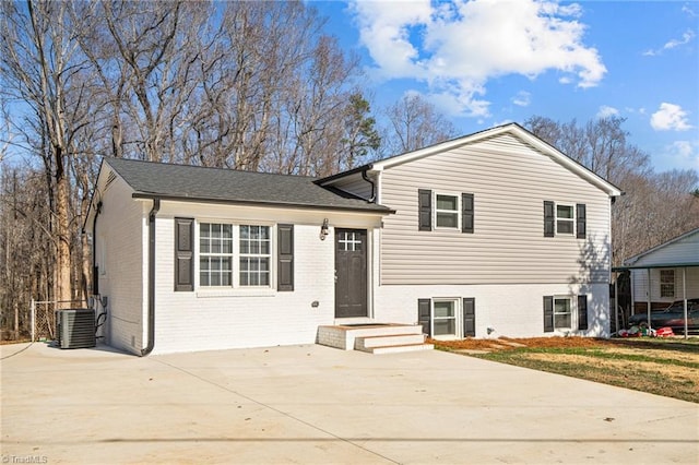 tri-level home featuring central air condition unit