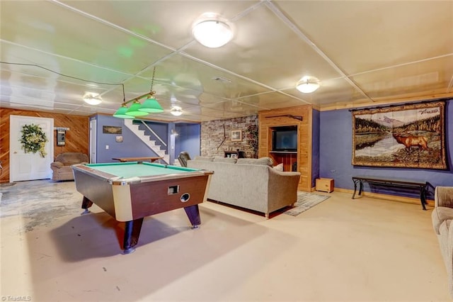 playroom with finished concrete floors, a paneled ceiling, billiards, and wooden walls