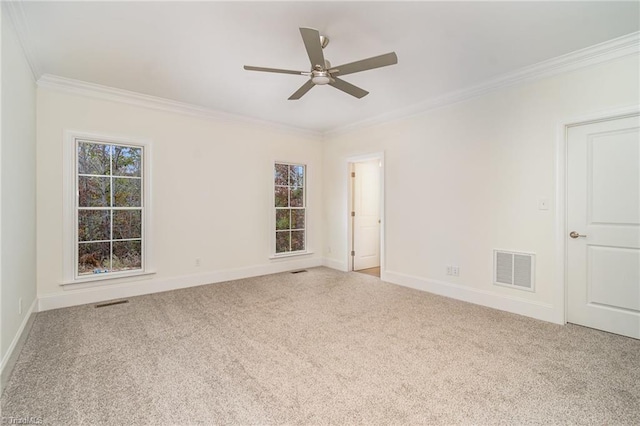 empty room with carpet flooring, ceiling fan, and crown molding