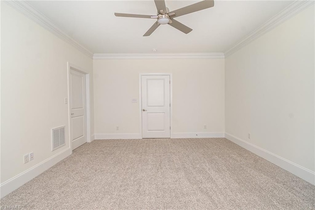 carpeted empty room with ceiling fan and ornamental molding