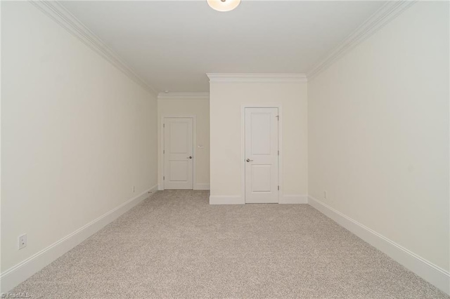 carpeted spare room featuring ornamental molding