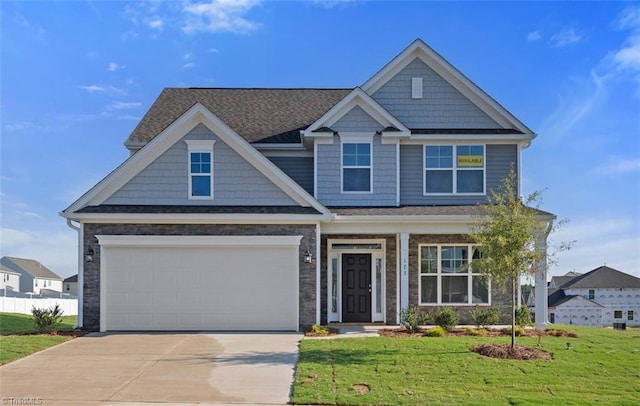 craftsman-style home featuring a garage and a front yard