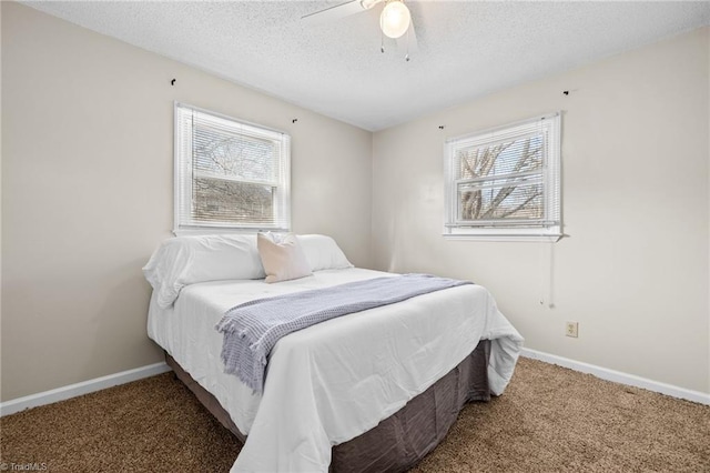 bedroom featuring ceiling fan, carpet floors, and a textured ceiling