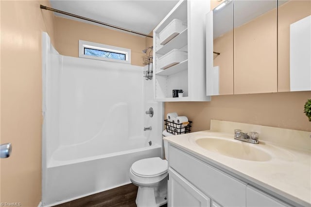 full bathroom with hardwood / wood-style flooring, toilet, vanity, and shower / bathtub combination