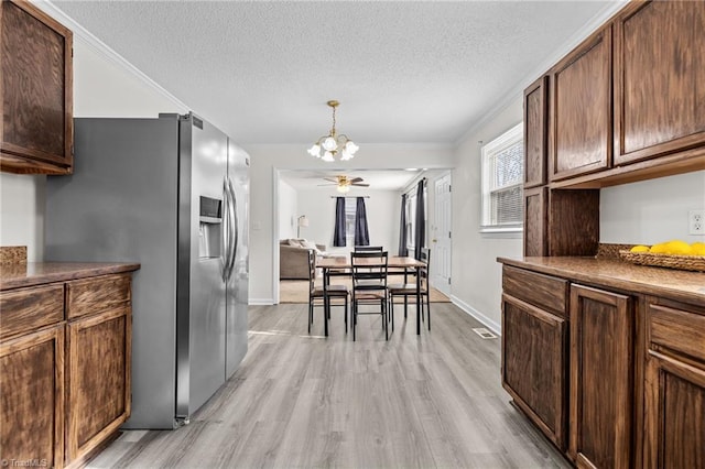 kitchen with light hardwood / wood-style floors, stainless steel fridge with ice dispenser, ornamental molding, a textured ceiling, and ceiling fan with notable chandelier